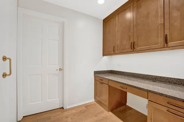 a utility room with granite countertop cabinets and sink