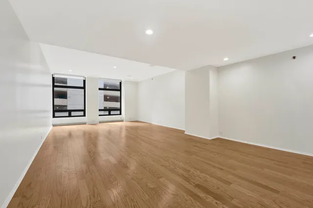 a view of an empty room with closet and cabinet