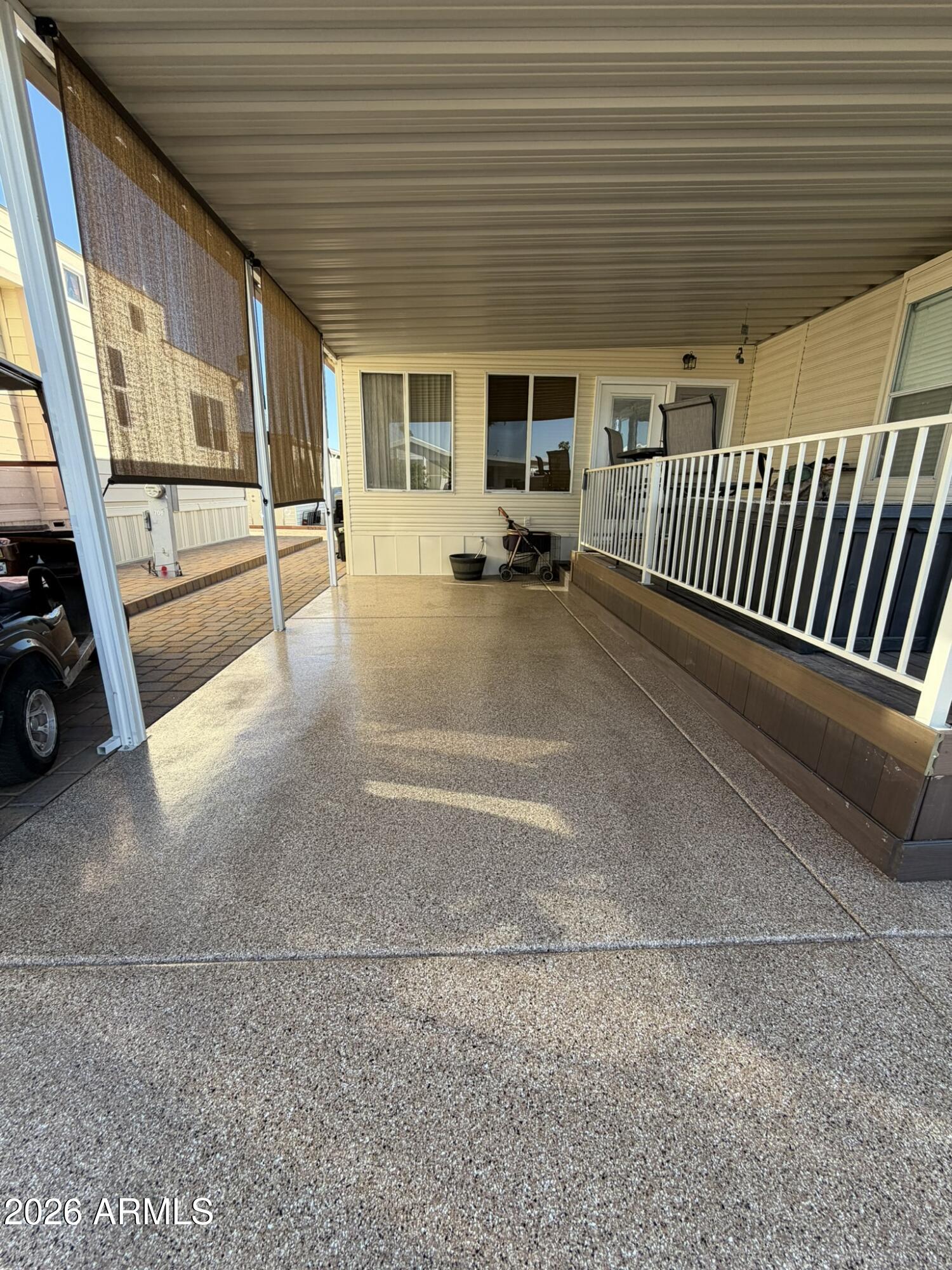 7750 East Broadway Road, Unit 707 Mesa, AZ 85208 - Photo 3 of 17 a view of a porch with wooden floor and furniture