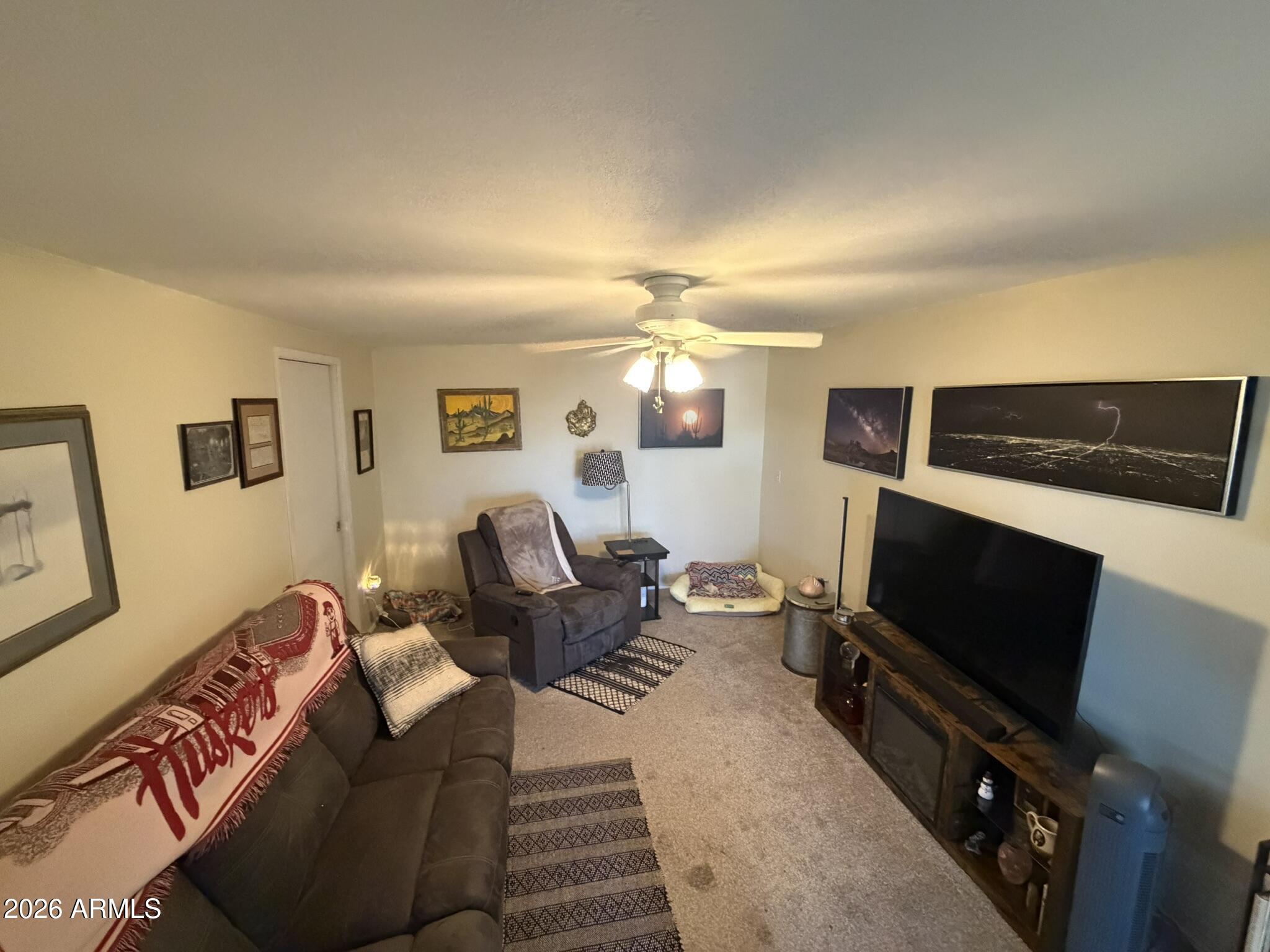 7750 East Broadway Road, Unit 707 Mesa, AZ 85208 - Photo 5 of 17 a living room with furniture and a flat screen tv