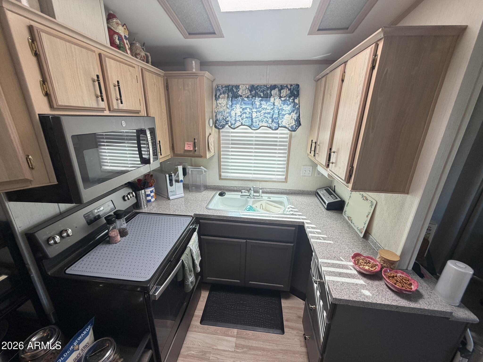 7750 East Broadway Road, Unit 707 Mesa, AZ 85208 - Photo 7 of 17 a bathroom with a sink a bathtub and a window