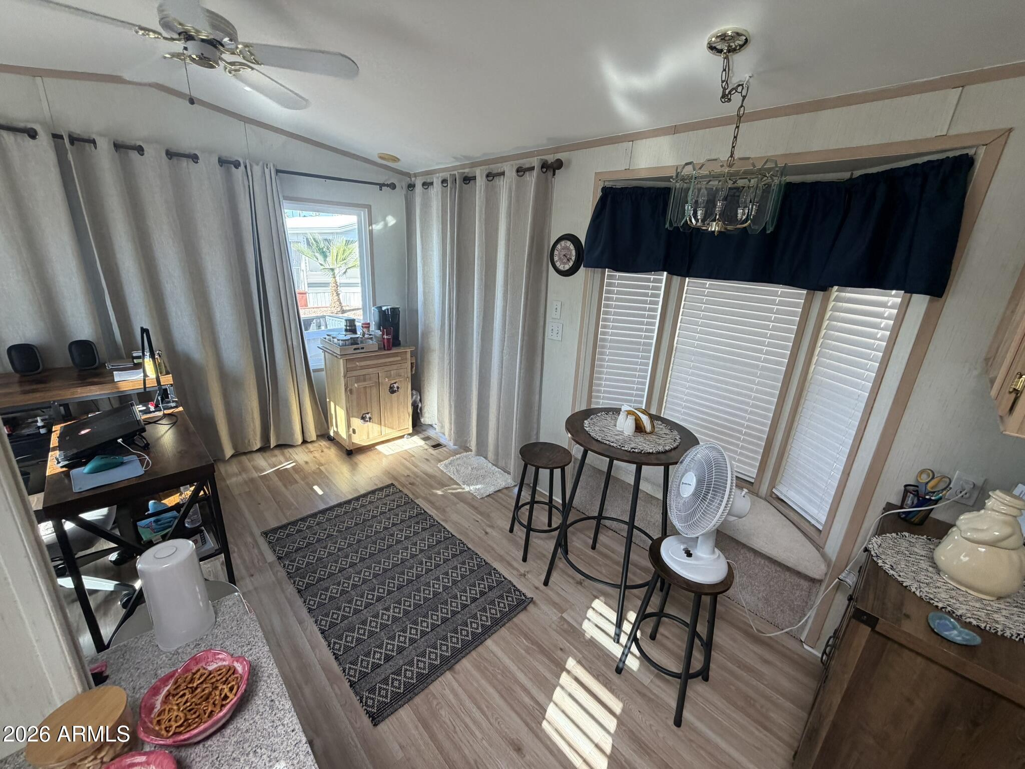 7750 East Broadway Road, Unit 707 Mesa, AZ 85208 - Photo 8 of 17 a view of a dining room with furniture window and wooden floor
