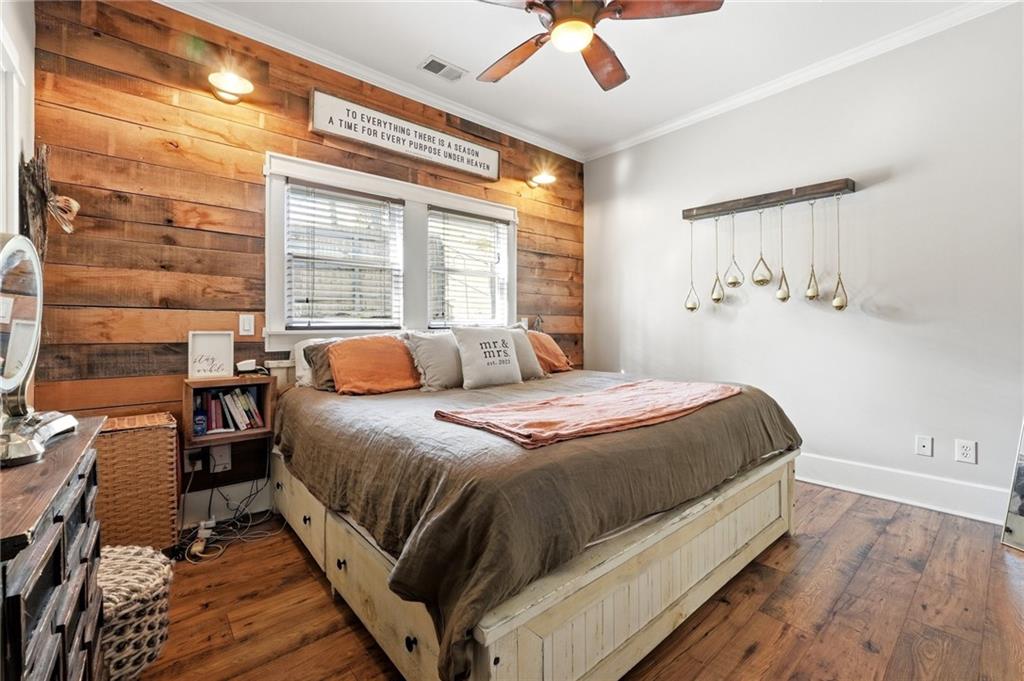 275 Strippling Street Ball Ground, GA 30107 - Photo 14 of 40 a bedroom with a bed and wooden floor