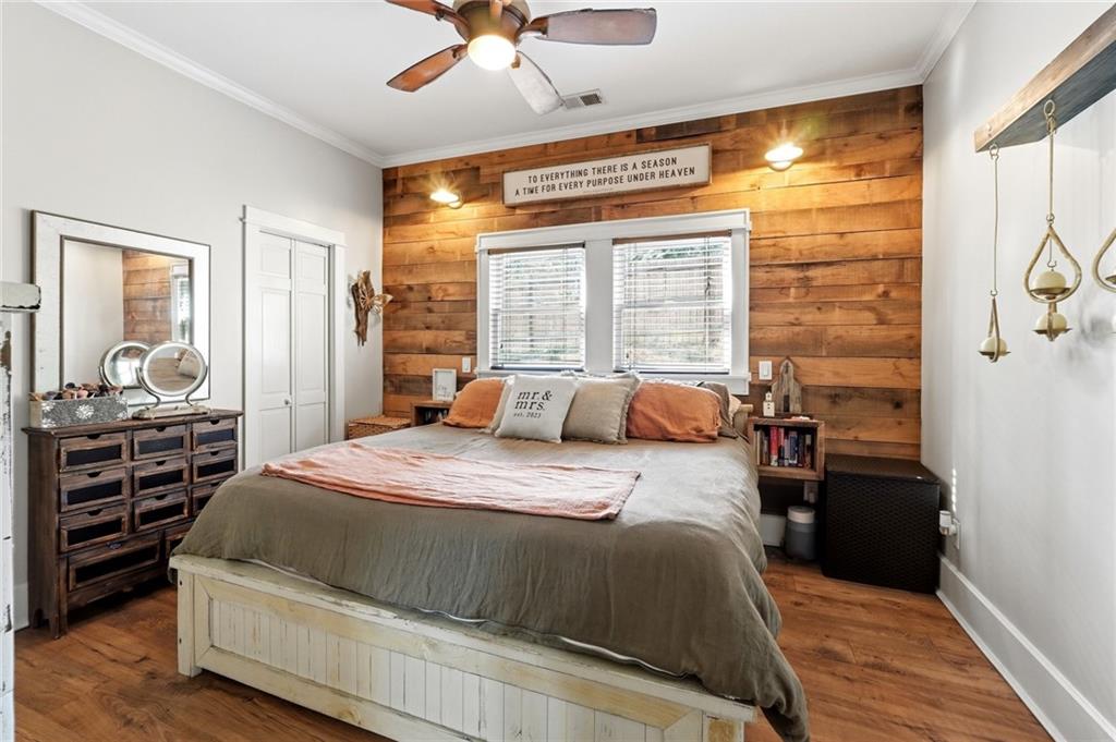 275 Strippling Street Ball Ground, GA 30107 - Photo 15 of 40 a bedroom with a bed and wooden floor