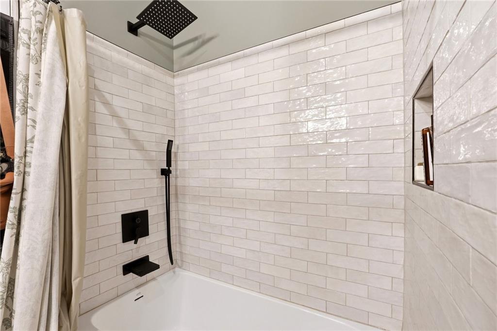 275 Strippling Street Ball Ground, GA 30107 - Photo 17 of 40 a bathroom with a shower and a sink