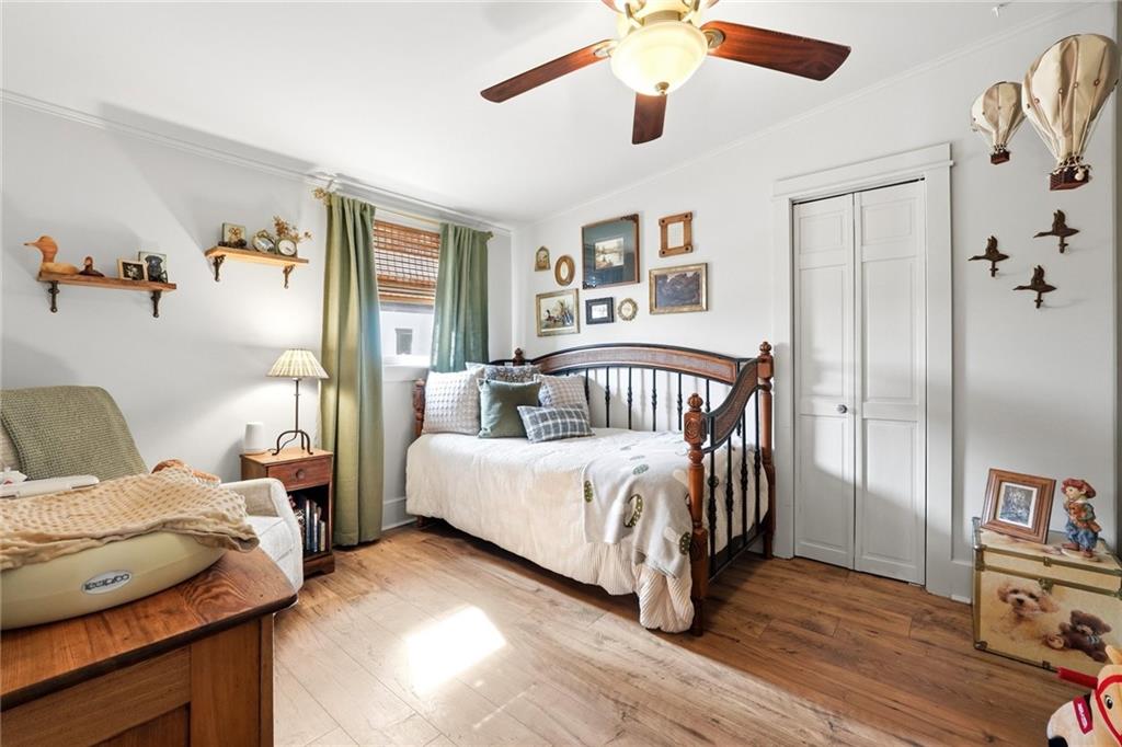 275 Strippling Street Ball Ground, GA 30107 - Photo 18 of 40 a bedroom with a bed and a chandelier