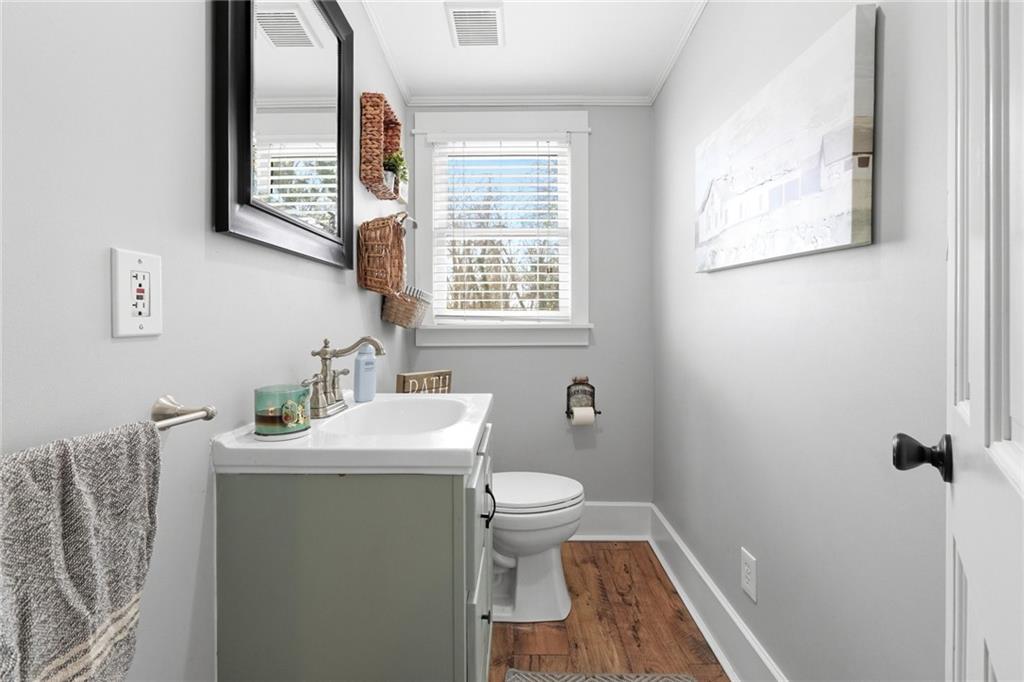 275 Strippling Street Ball Ground, GA 30107 - Photo 20 of 40 a bathroom with a toilet sink and mirror