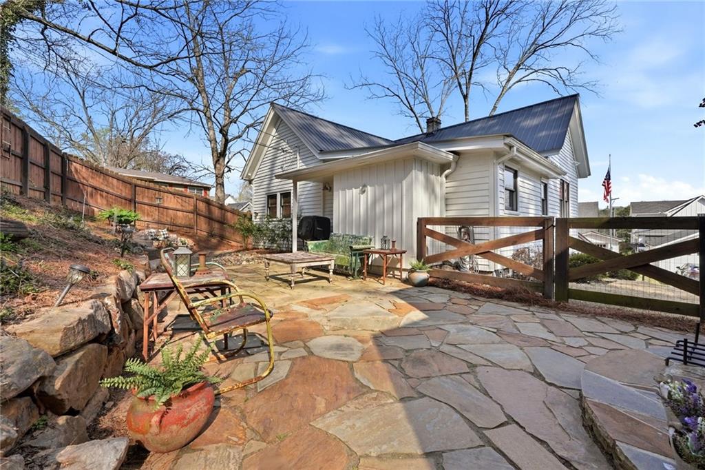 275 Strippling Street Ball Ground, GA 30107 - Photo 25 of 40 a view of a house with backyard and furniture