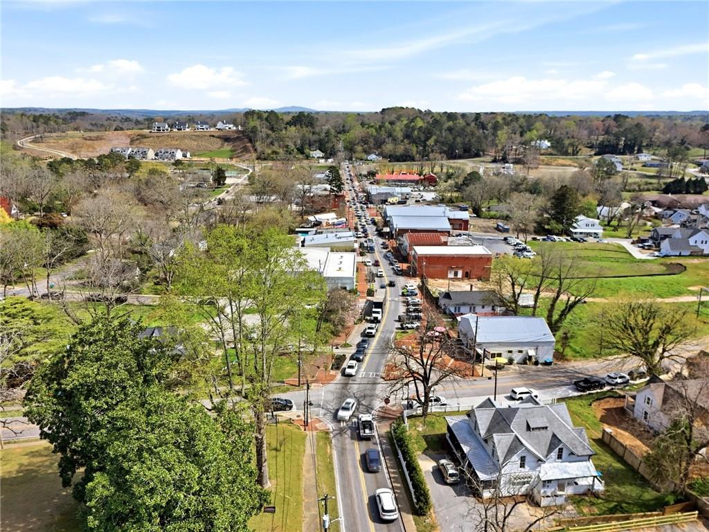 275 Strippling Street Ball Ground, GA 30107 - Photo 28 of 40 an aerial view of residential building and lake