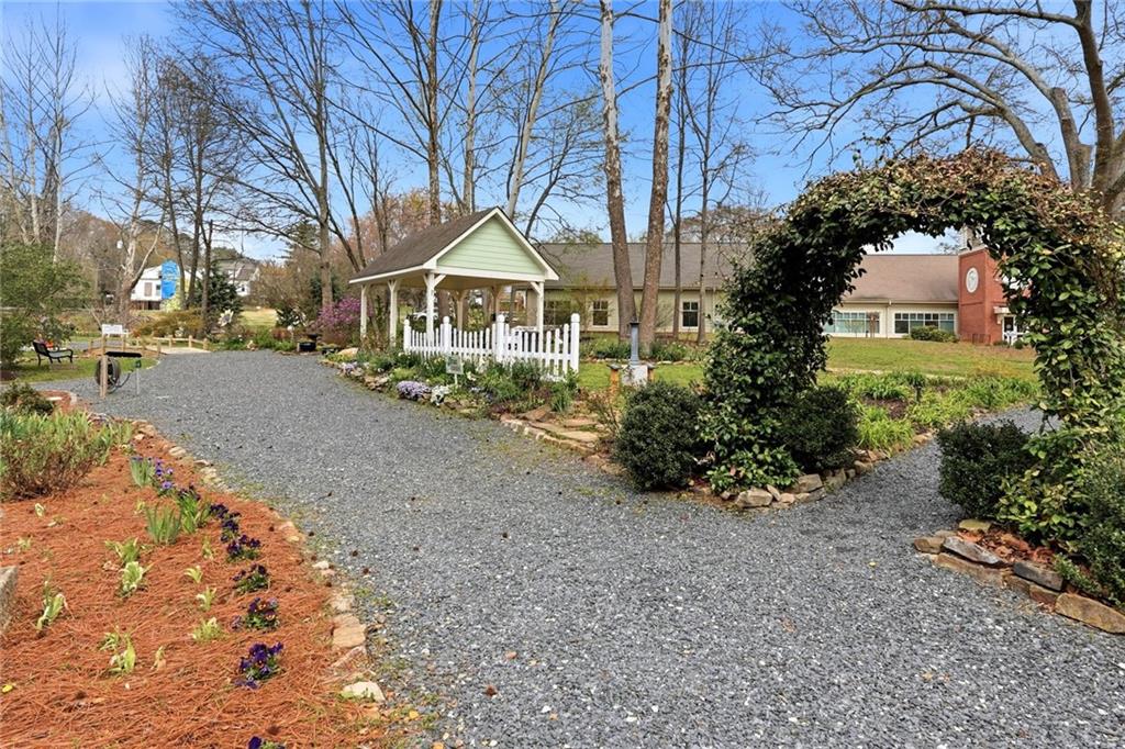 275 Strippling Street Ball Ground, GA 30107 - Photo 30 of 40 a front view of a house with a yard