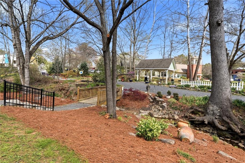 275 Strippling Street Ball Ground, GA 30107 - Photo 31 of 40 a view of a yard with a tree