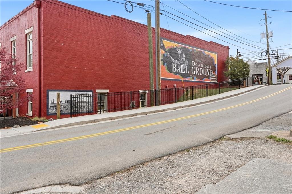 275 Strippling Street Ball Ground, GA 30107 - Photo 32 of 40 a street sign on a brick wall