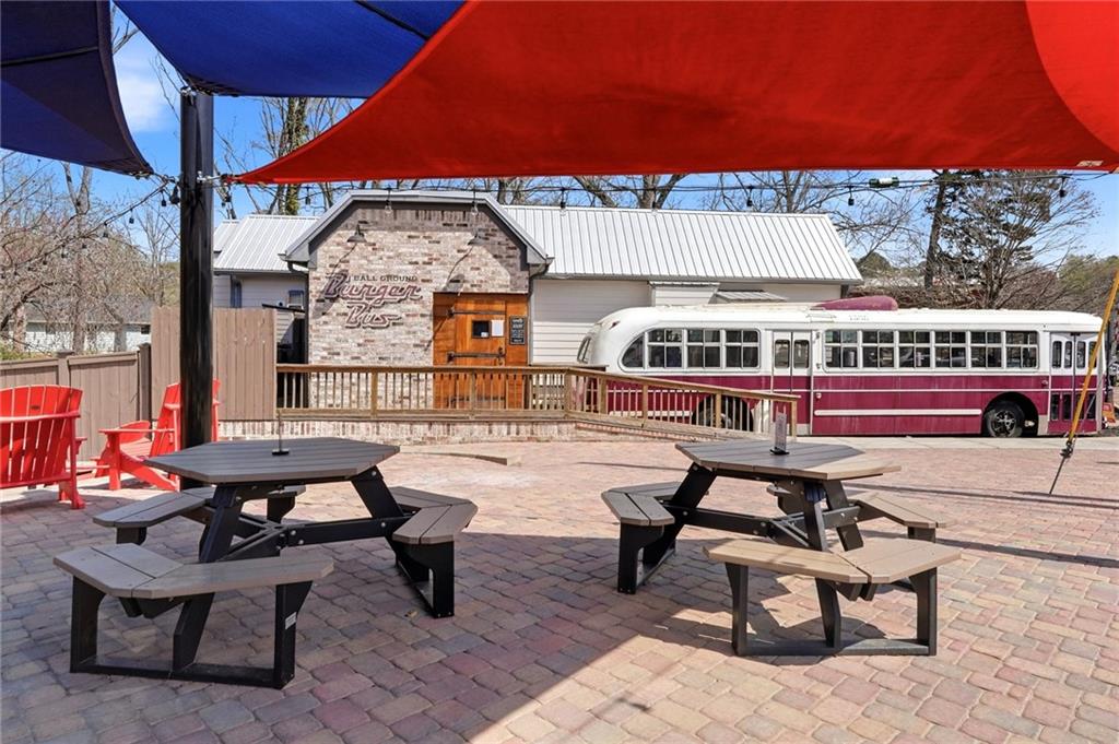 275 Strippling Street Ball Ground, GA 30107 - Photo 34 of 40 a view of a roof deck with table and chairs under an umbrella
