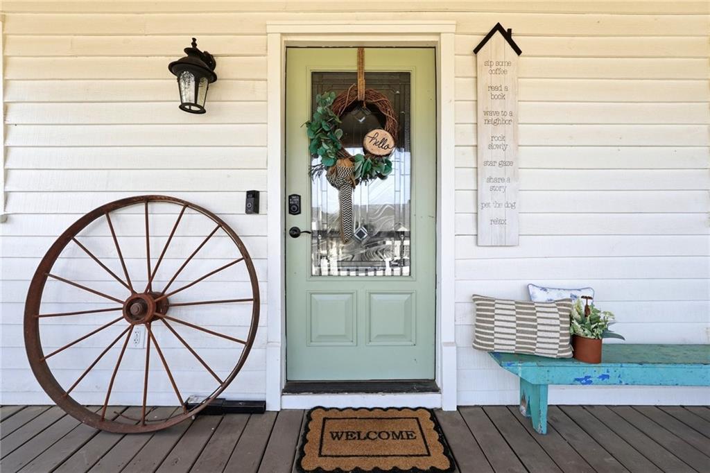 275 Strippling Street Ball Ground, GA 30107 - Photo 5 of 40 a view of a hallway with wooden floor and a chandelier
