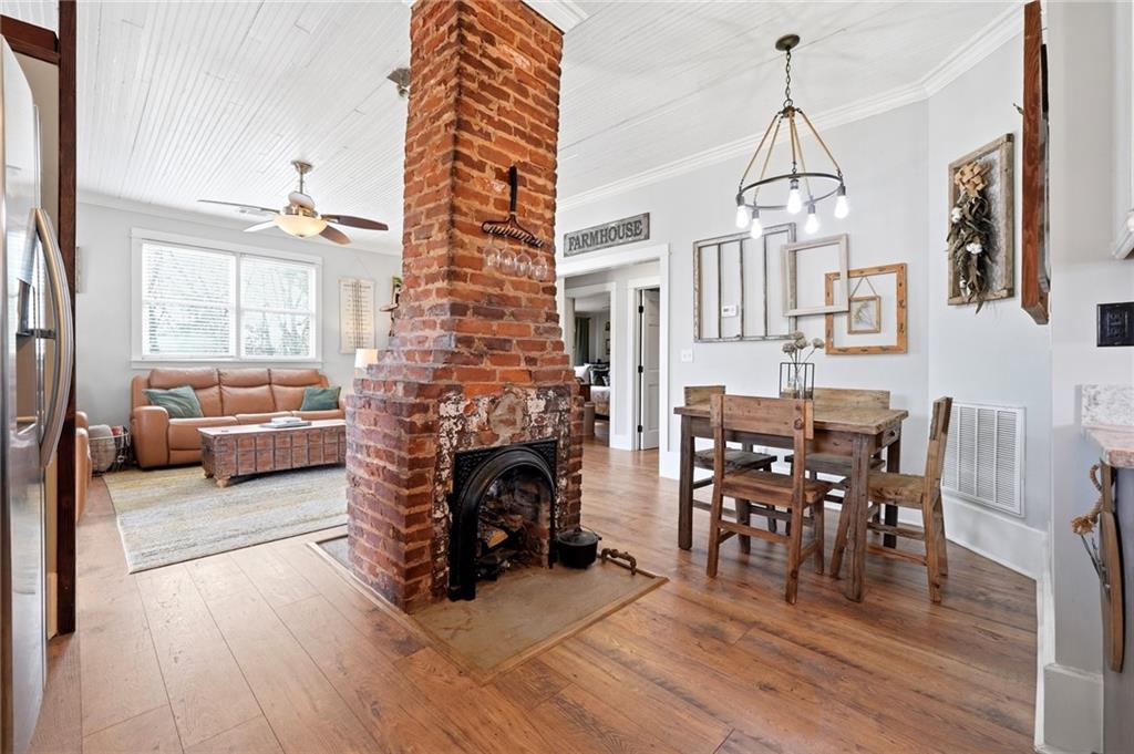 275 Strippling Street Ball Ground, GA 30107 - Photo 10 of 40 a living room with furniture a fireplace and a chandelier
