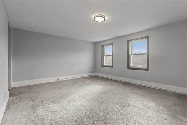 a view of an empty room with windows