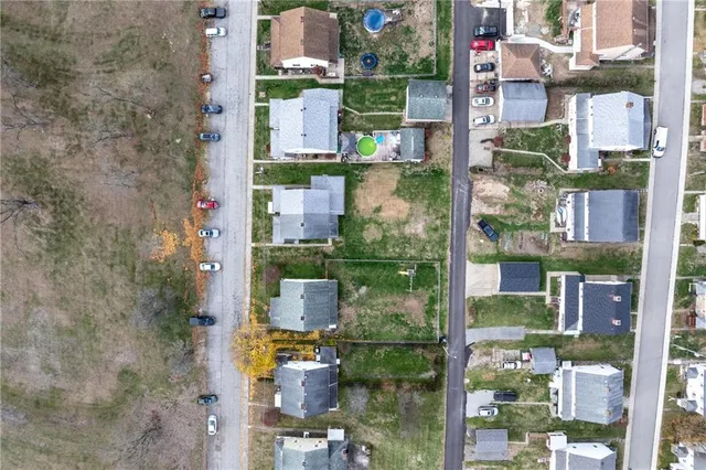 an aerial view of a house with a yard and lake view