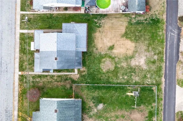 an aerial view of a backyard with plants and outdoor seating
