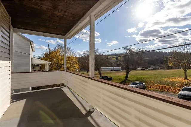 a view of a balcony with a yard