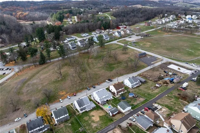 an aerial view of house with yard swimming pool and ocean view