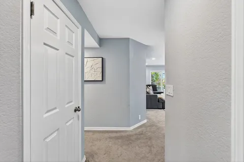 a view of a hallway with wooden floor and closet