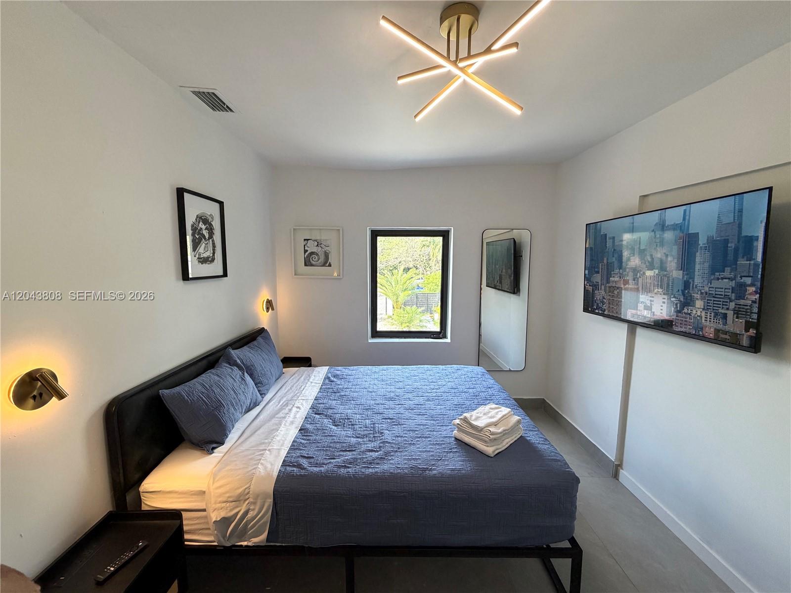 2134 Southwest 11th Street Miami, FL 33135 - Photo 7 of 13 a bedroom with a bed and a table in it