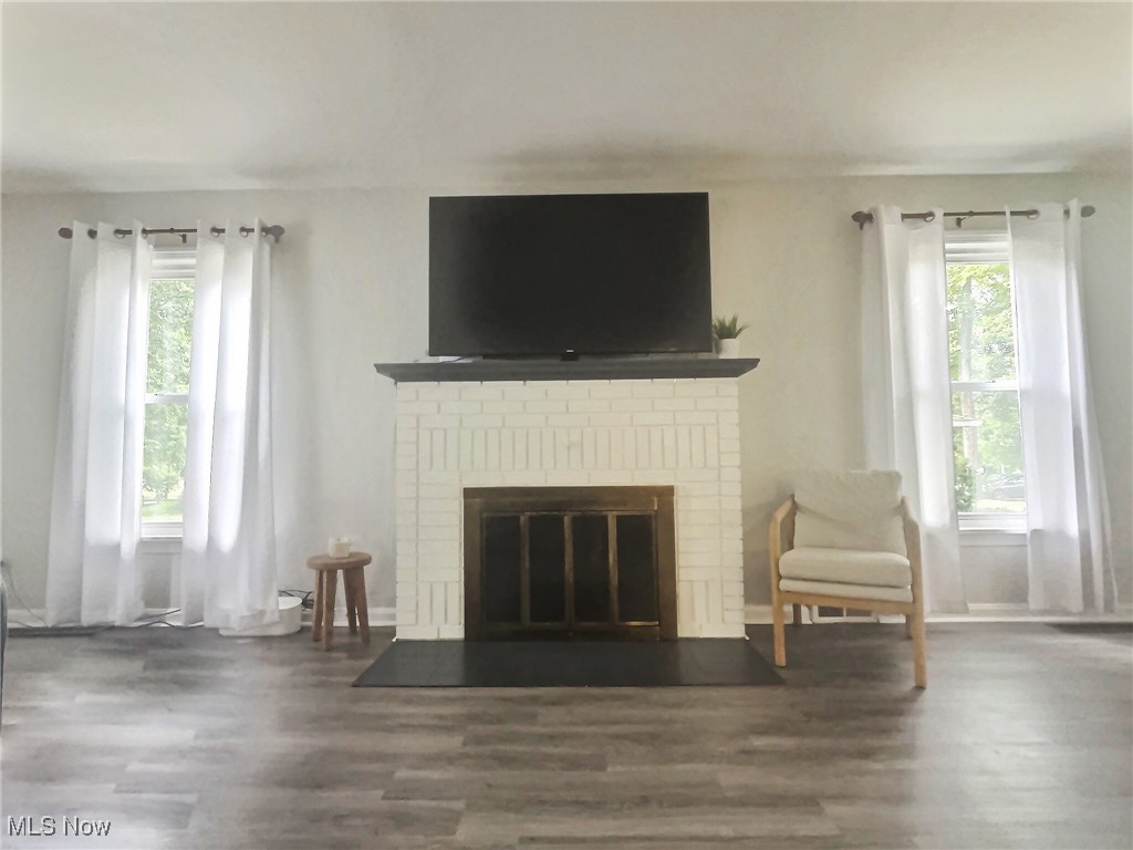 3688 Easton Road Norton, OH 44203 - Photo 22 of 37 Unfurnished living room featuring a brick fireplace, plenty of natural light, and wood-type flooring