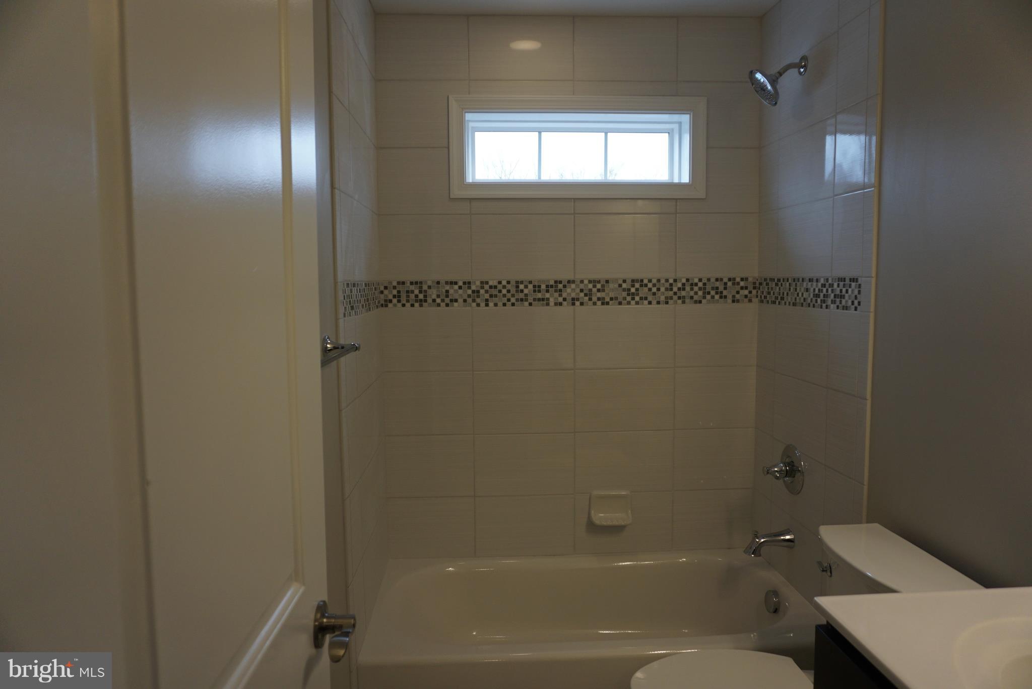 3611 Florida Road Baltimore, MD 21244 - Photo 11 of 30 a bathroom with a granite countertop sink toilet and shower