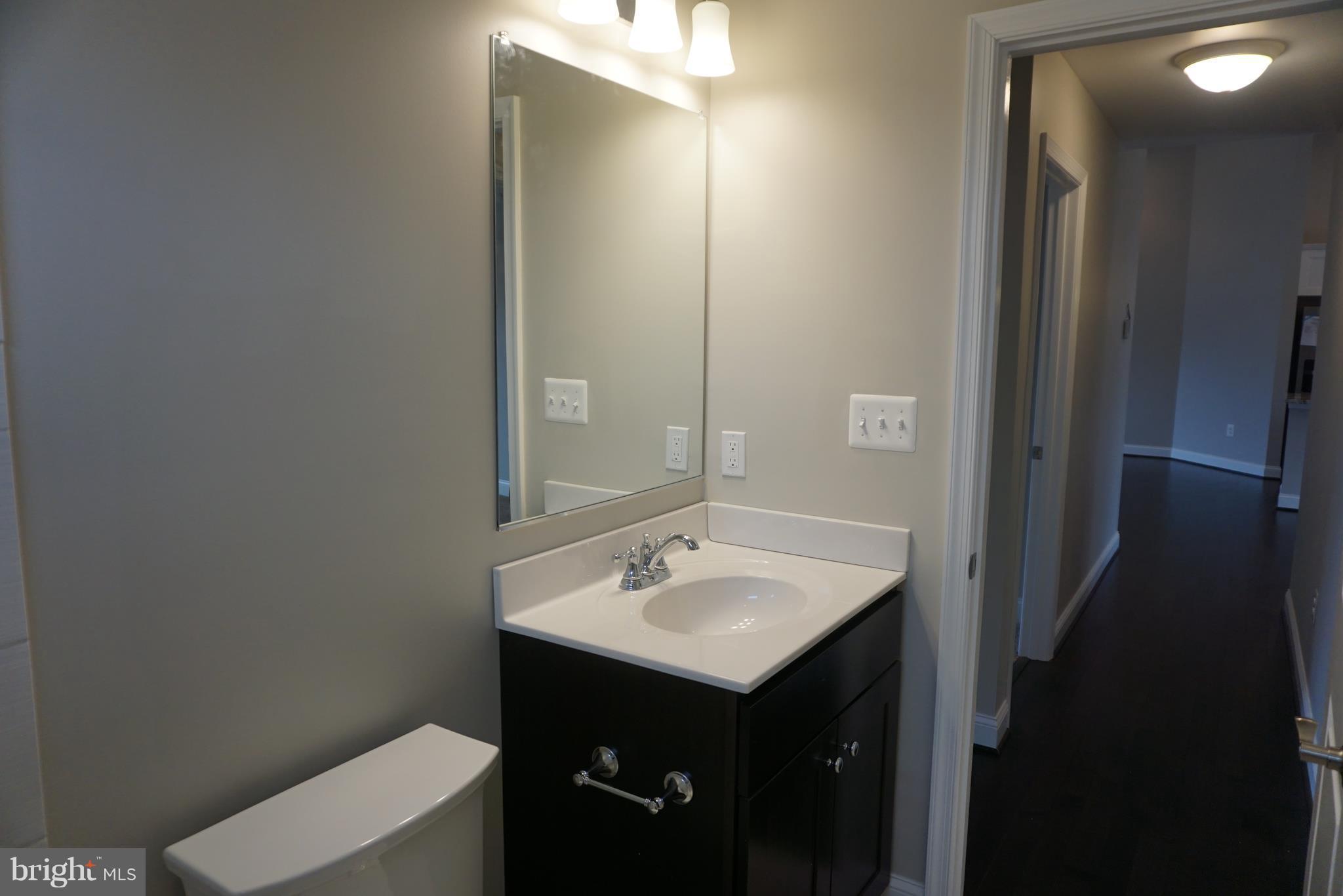 3611 Florida Road Baltimore, MD 21244 - Photo 12 of 30 a bathroom with a sink and a mirror