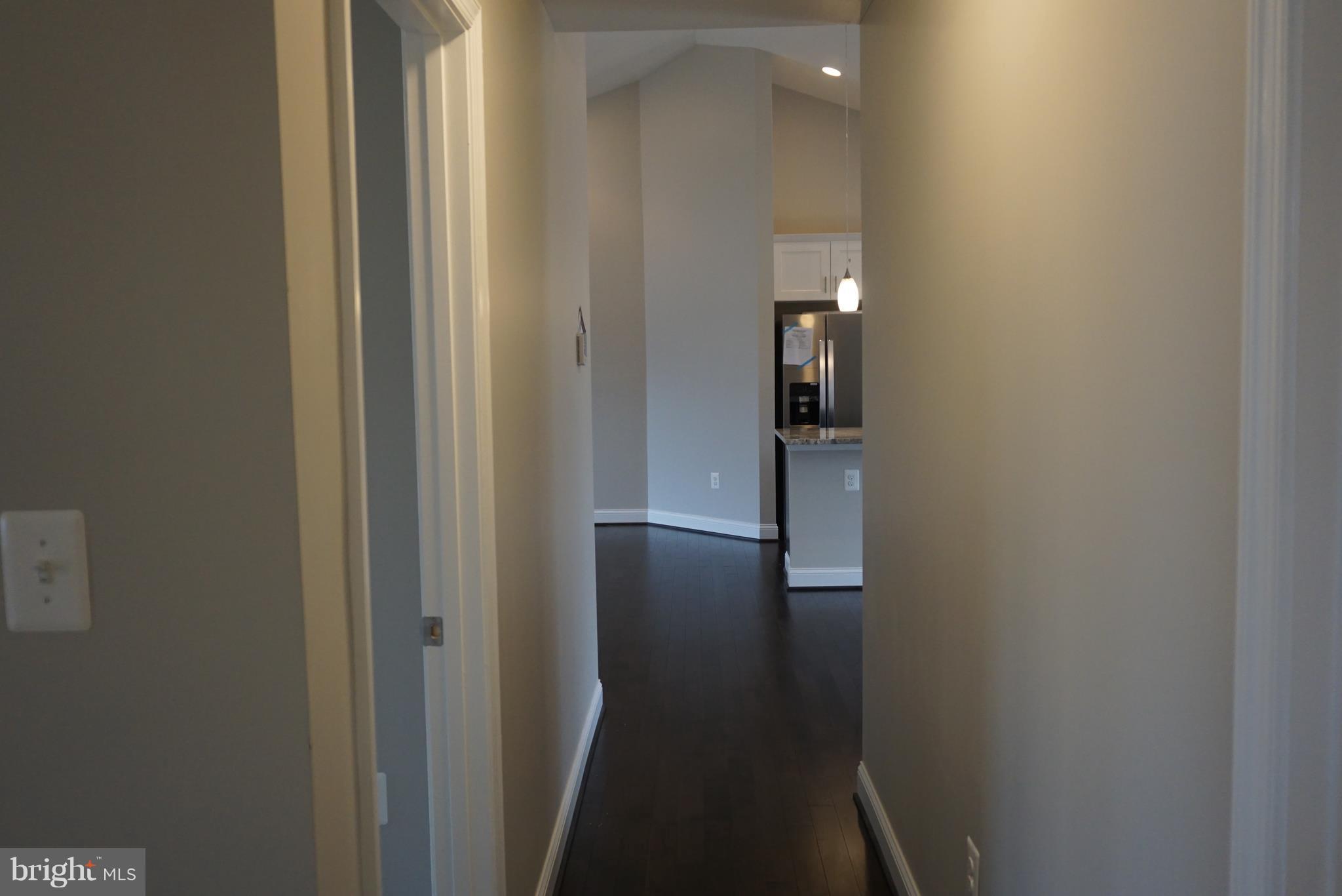 3611 Florida Road Baltimore, MD 21244 - Photo 13 of 30 a view of hallway with stairs and wooden floor
