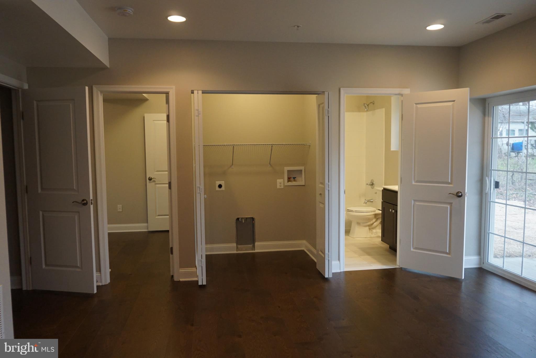 3611 Florida Road Baltimore, MD 21244 - Photo 19 of 30 an empty room with wooden floor and a bathroom