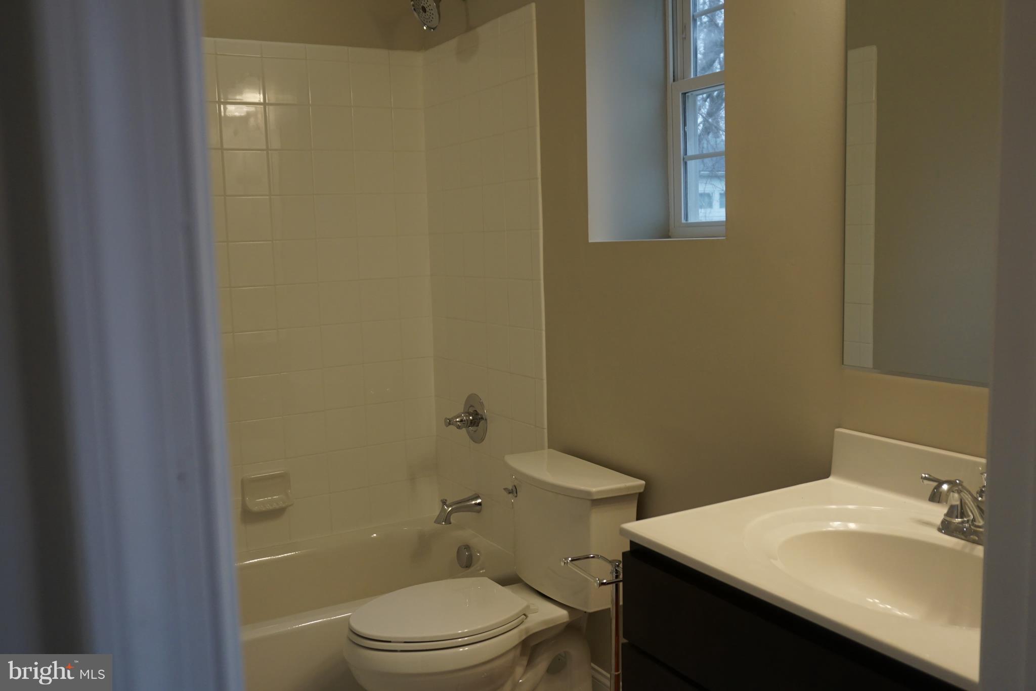 3611 Florida Road Baltimore, MD 21244 - Photo 20 of 30 a bathroom with a sink a toilet and shower