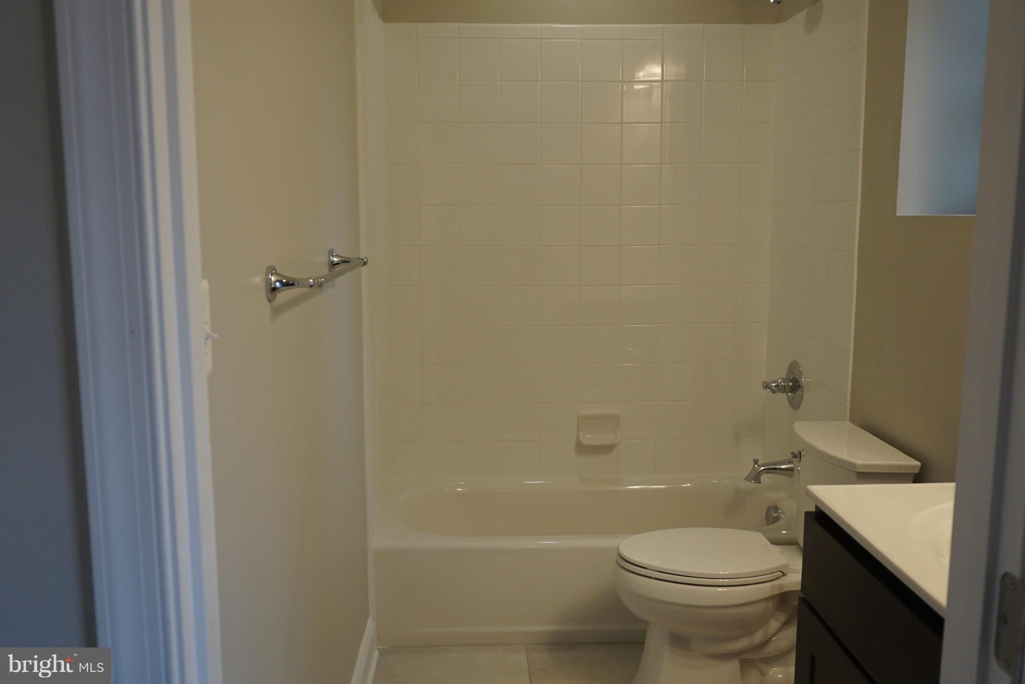 3611 Florida Road Baltimore, MD 21244 - Photo 21 of 30 a bathroom with a toilet a sink and shower