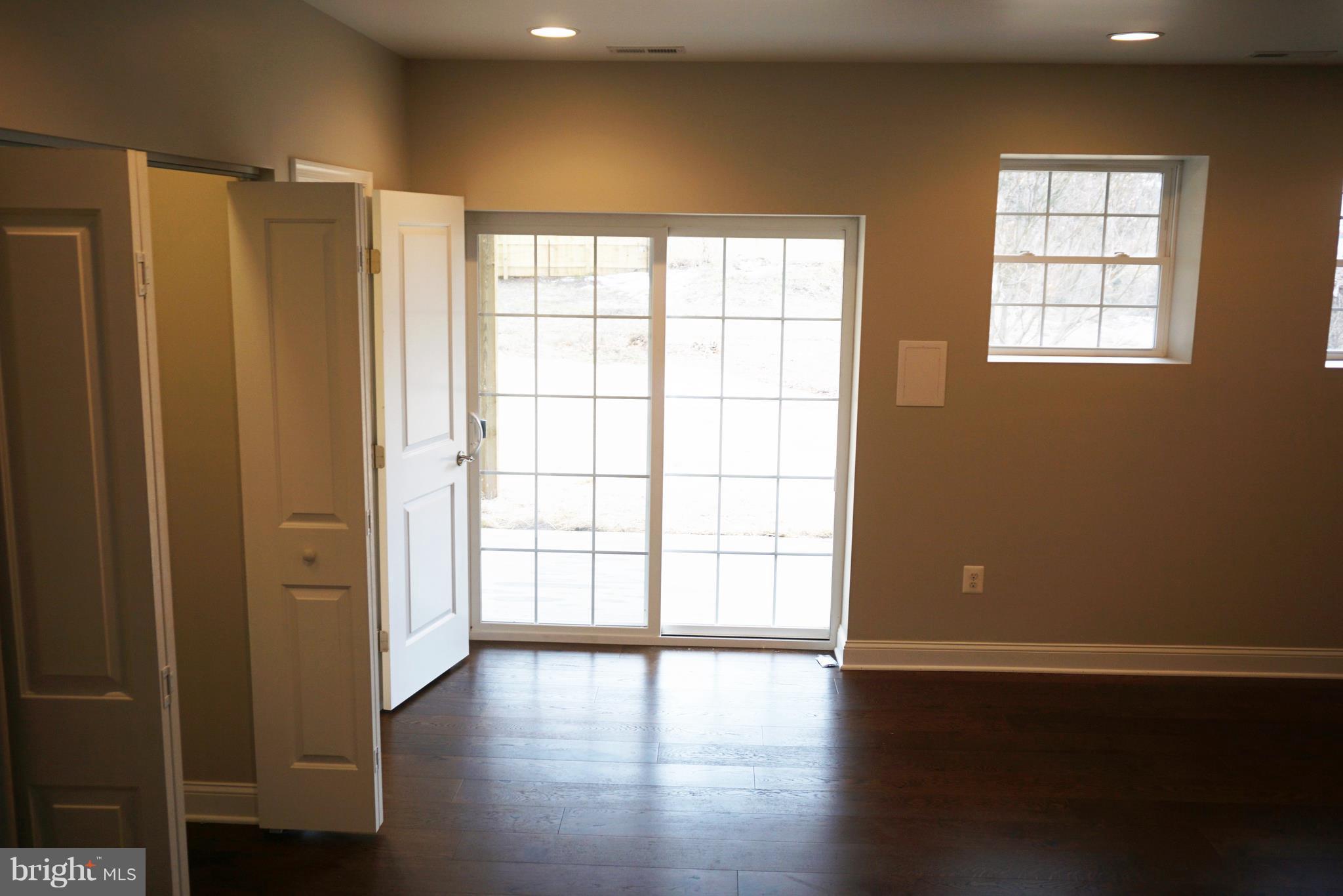 3611 Florida Road Baltimore, MD 21244 - Photo 23 of 30 an empty room with wooden floor and windows