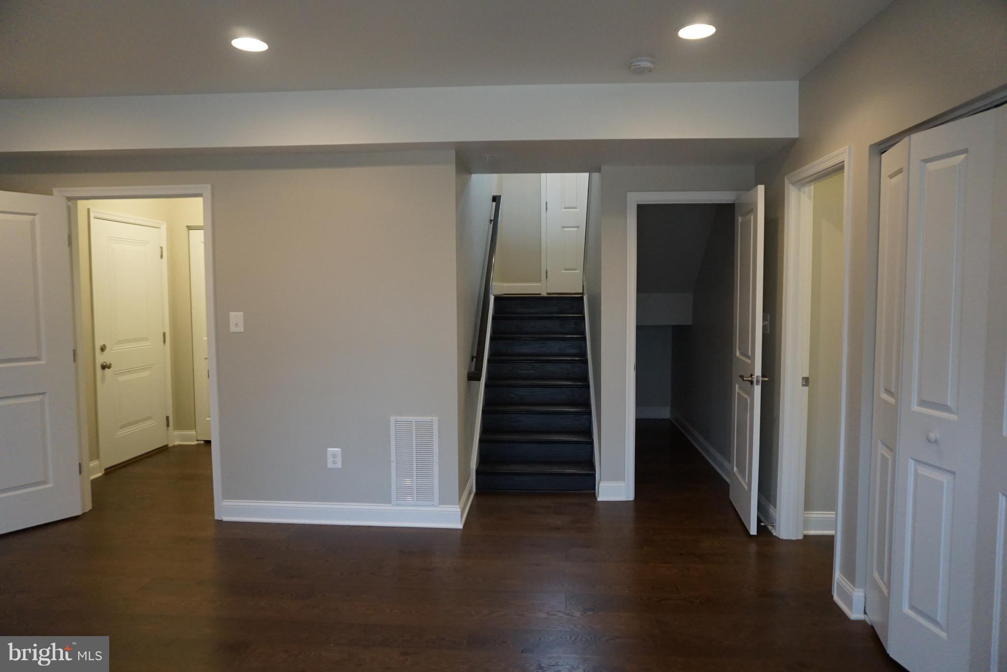 3611 Florida Road Baltimore, MD 21244 - Photo 25 of 30 a view of a hallway with wooden floor and stairs