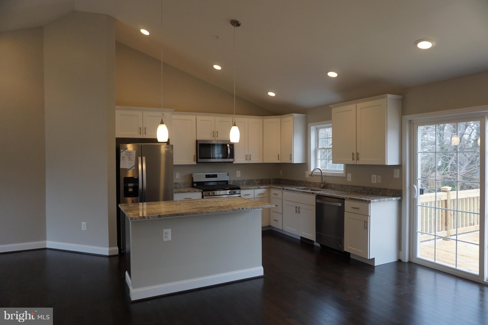 3611 Florida Road Baltimore, MD 21244 - Photo 5 of 30 a kitchen with stainless steel appliances granite countertop a sink stove and refrigerator