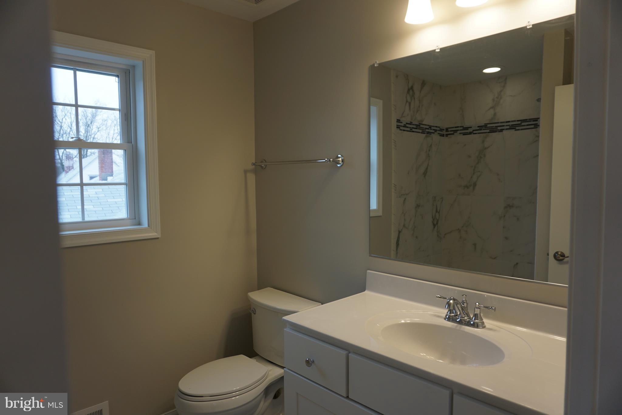 3611 Florida Road Baltimore, MD 21244 - Photo 10 of 30 a bathroom with a sink toilet vanity and shower
