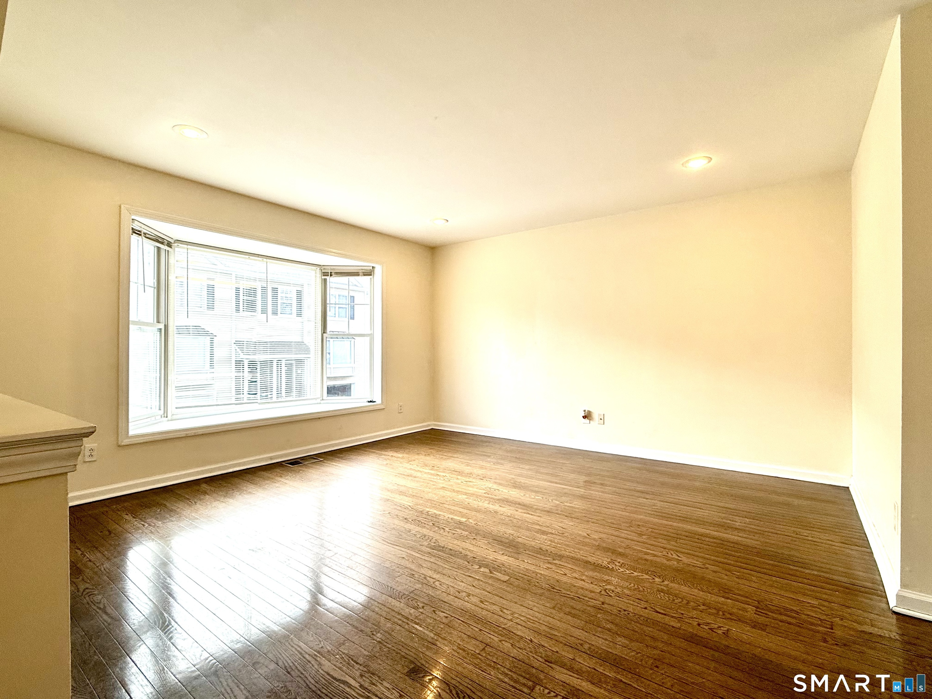 15 Scuppo Road, Unit 603 Danbury, CT 06811 - Photo 5 of 29 a view of an empty room with wooden floor and a window