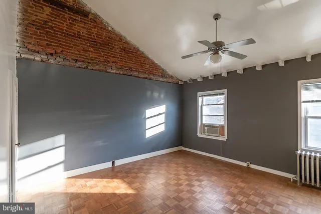 a view of a livingroom with a ceiling fan and window