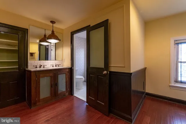 a bathroom with a double vanity sink and a mirror