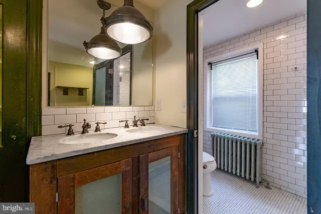 a bathroom with a double vanity sink and a mirror