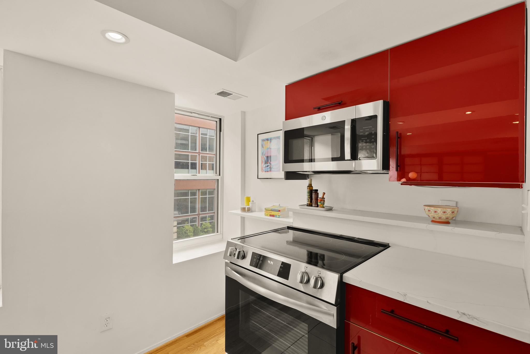 2370 Champlain Street Northwest, Unit 21 Washington, DC 20009 - Photo 8 of 22 a kitchen with a sink a stove and microwave