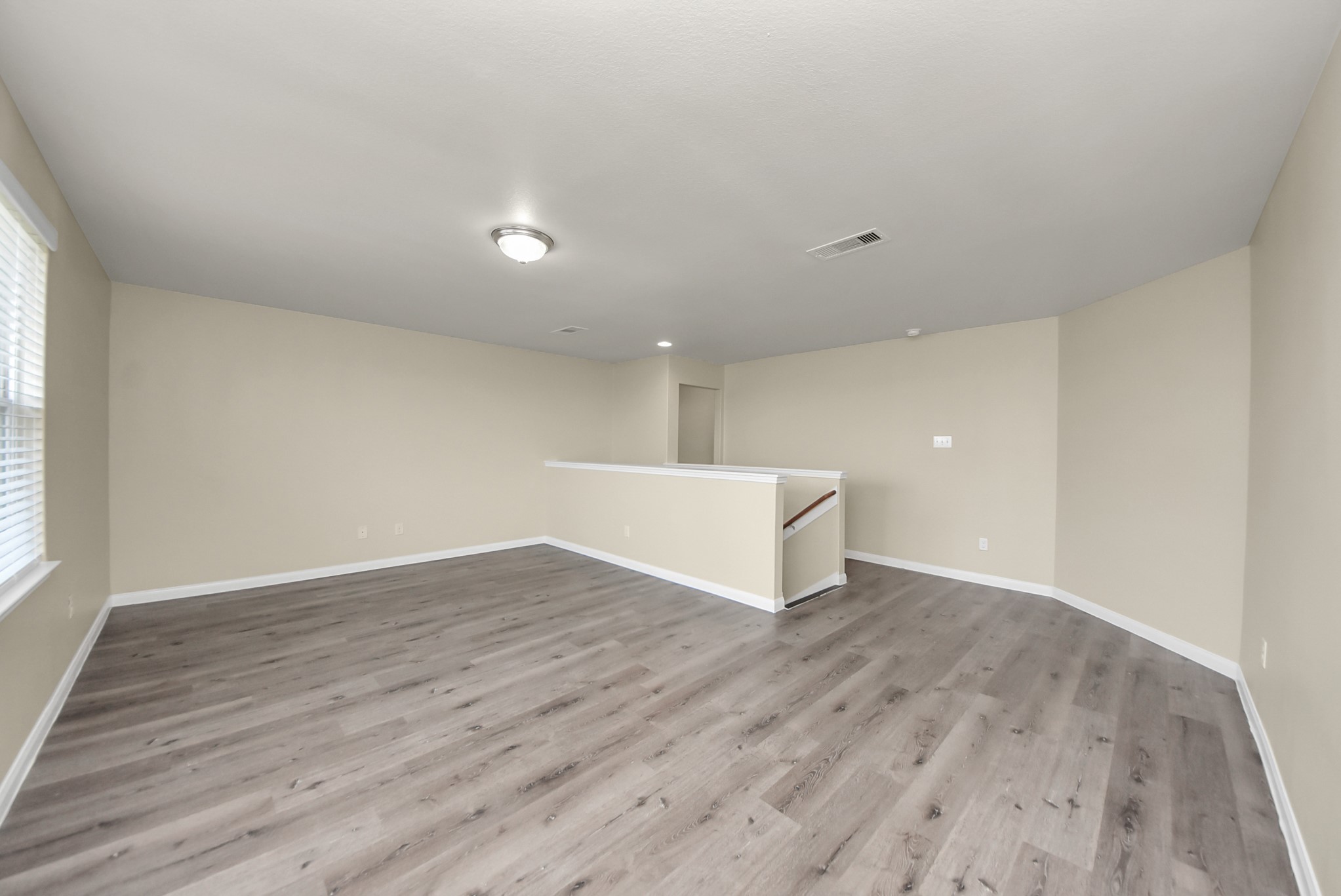1855 Garnet Breeze Drive Rosharon, TX 77583 - Photo 22 of 38 a view of an empty room with wooden floor and a window