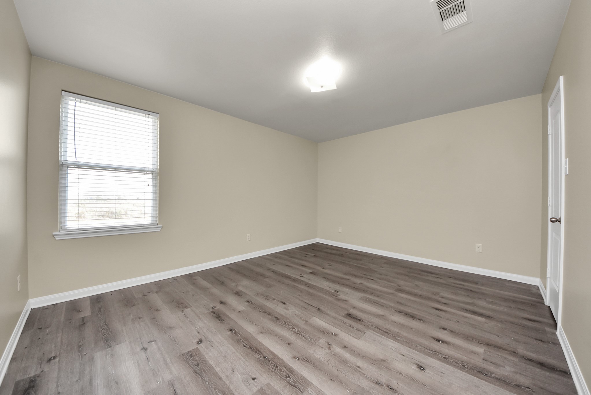 1855 Garnet Breeze Drive Rosharon, TX 77583 - Photo 23 of 38 an empty room with wooden floor and windows