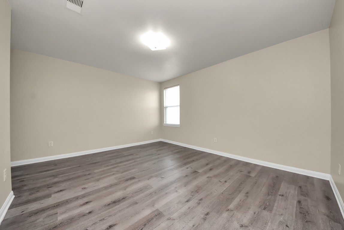 1855 Garnet Breeze Drive Rosharon, TX 77583 - Photo 26 of 38 a view of an empty room with wooden floor and window