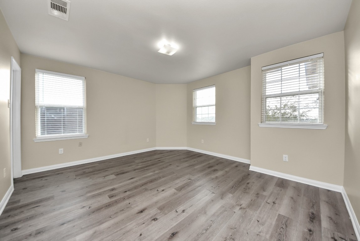1855 Garnet Breeze Drive Rosharon, TX 77583 - Photo 27 of 38 a view of an empty room with wooden floor and a window