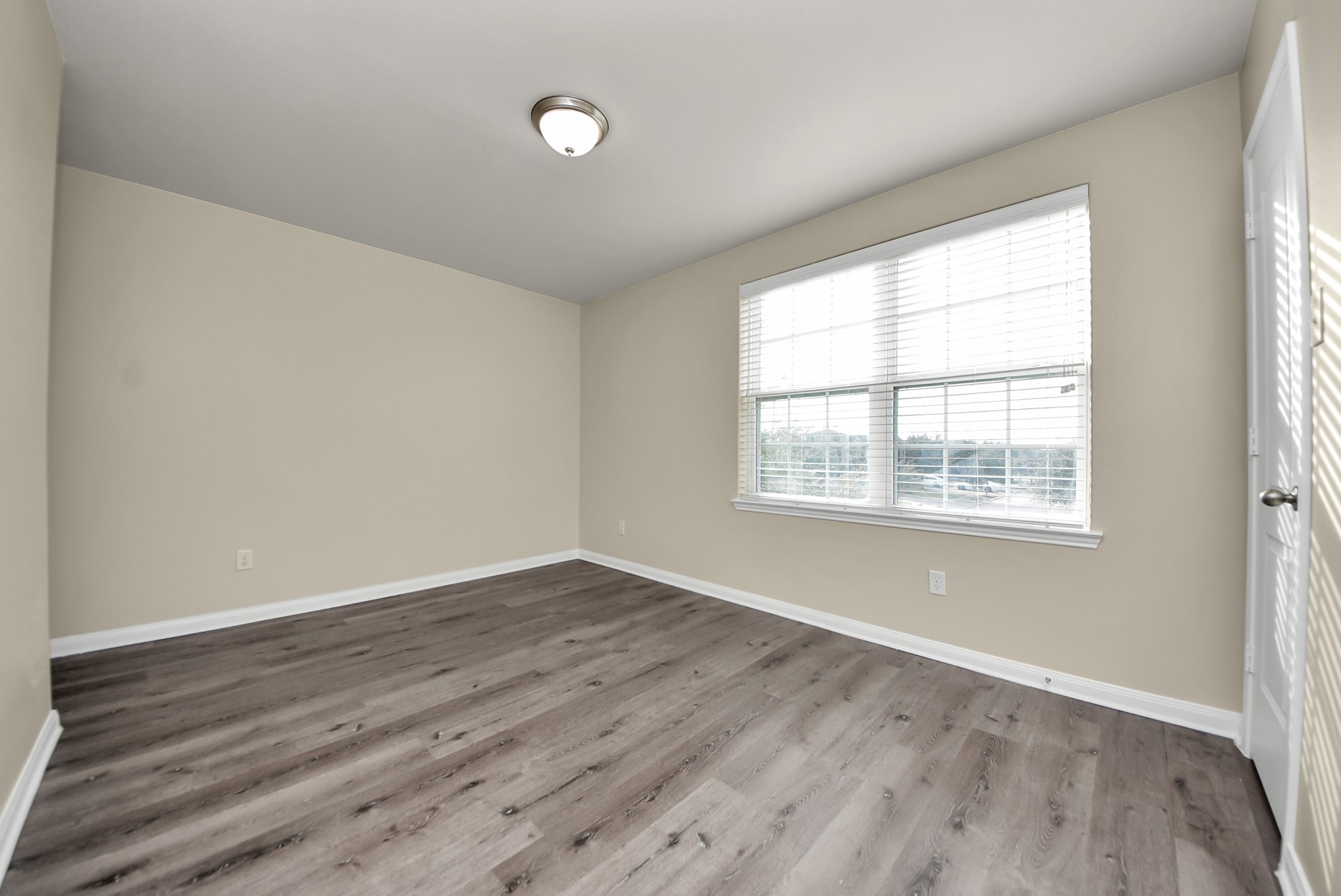 1855 Garnet Breeze Drive Rosharon, TX 77583 - Photo 34 of 38 an empty room with wooden floor and windows