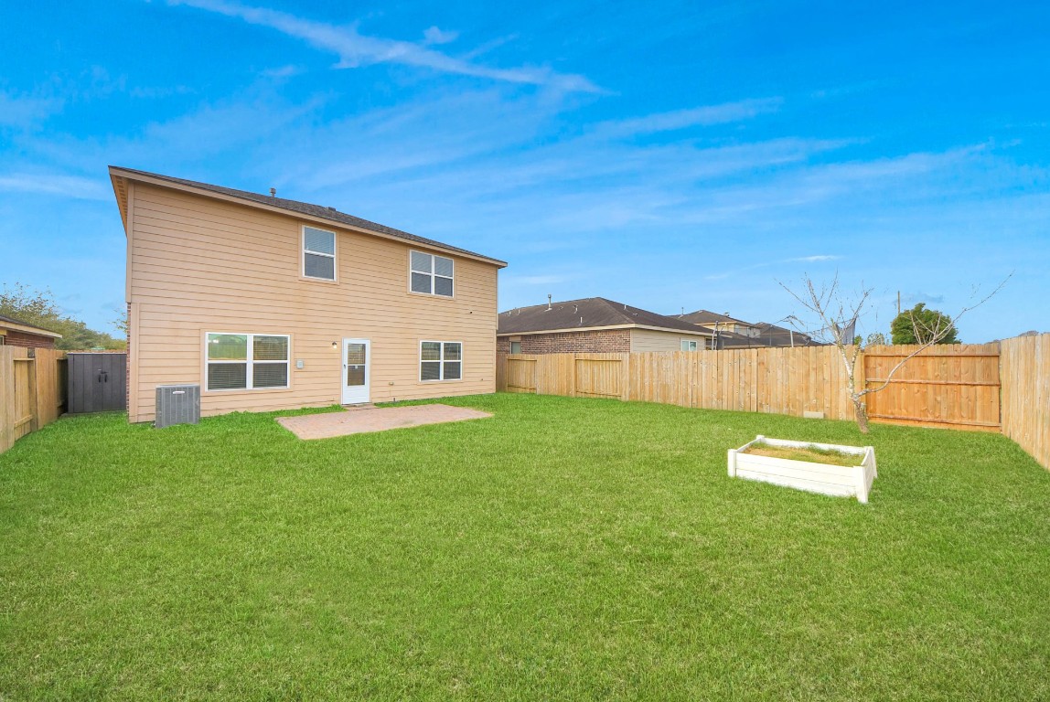 1855 Garnet Breeze Drive Rosharon, TX 77583 - Photo 38 of 38 a view of a backyard with table and chairs and wooden fence
