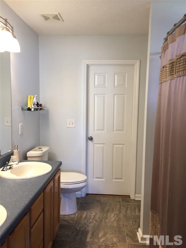 3613 Deering Drive Raleigh, NC 27616 - Photo 12 of 20 a bathroom with a sink toilet and shower