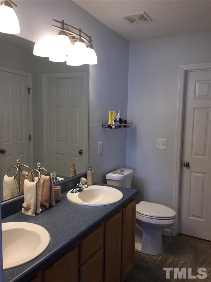 3613 Deering Drive Raleigh, NC 27616 - Photo 13 of 20 a bathroom with a sink toilet and a mirror